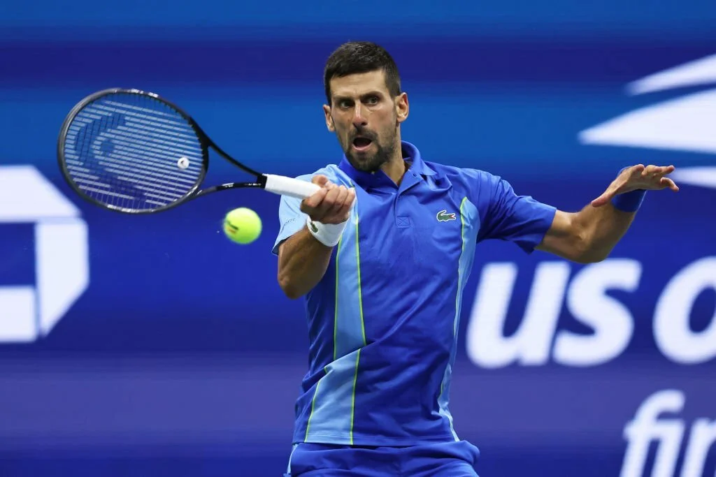 Novak Djokovic of Serbia plays a forehand against Daniil Medvedev of Russia