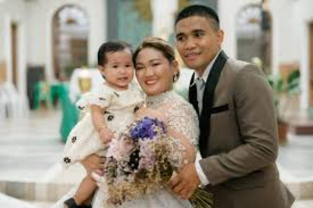 Marlon Tapales with his wife and child.